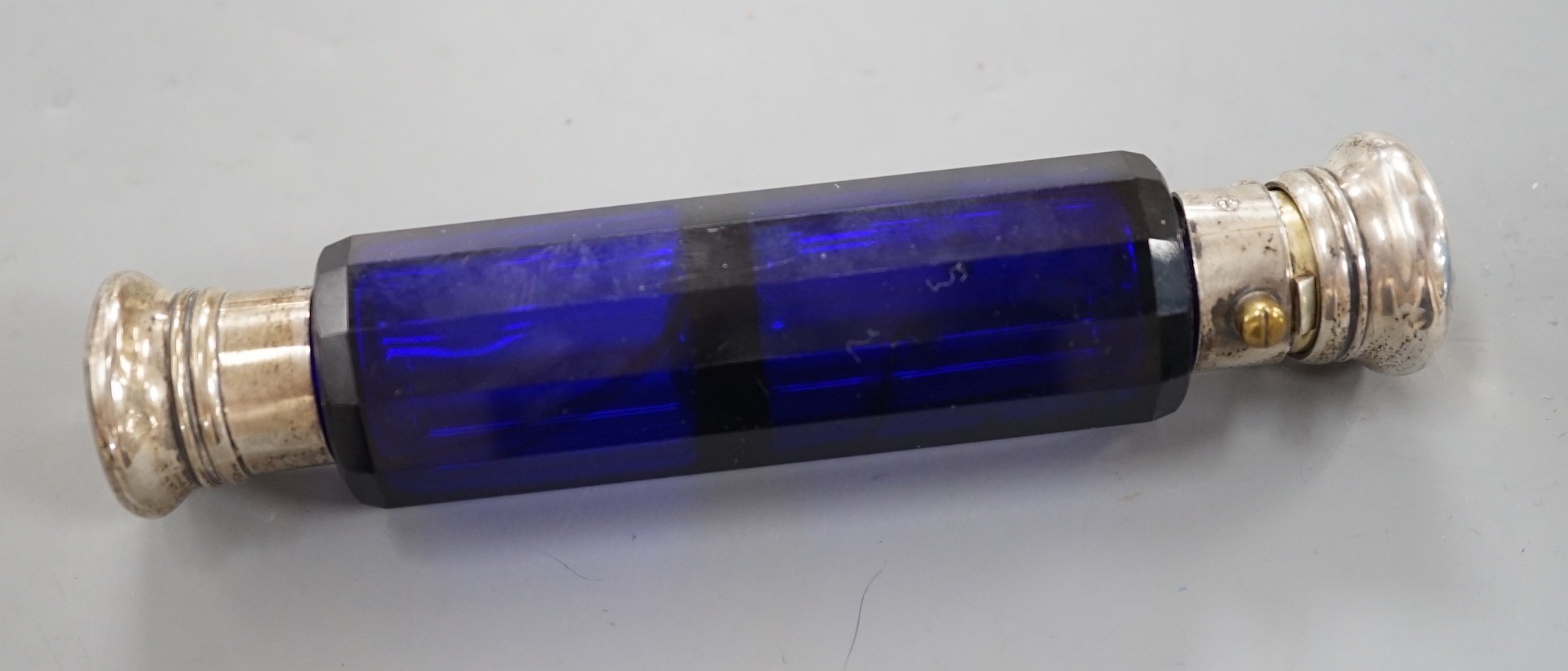 A late Victorian white metal mounted blue glass double ended scent bottle, 13.5cm.